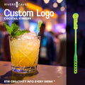 At the 18 custom branded cocktail stirrer in a rocks glass with a corporate reception background. Custom and personalized drink stirrer with logo engraved and cutout.