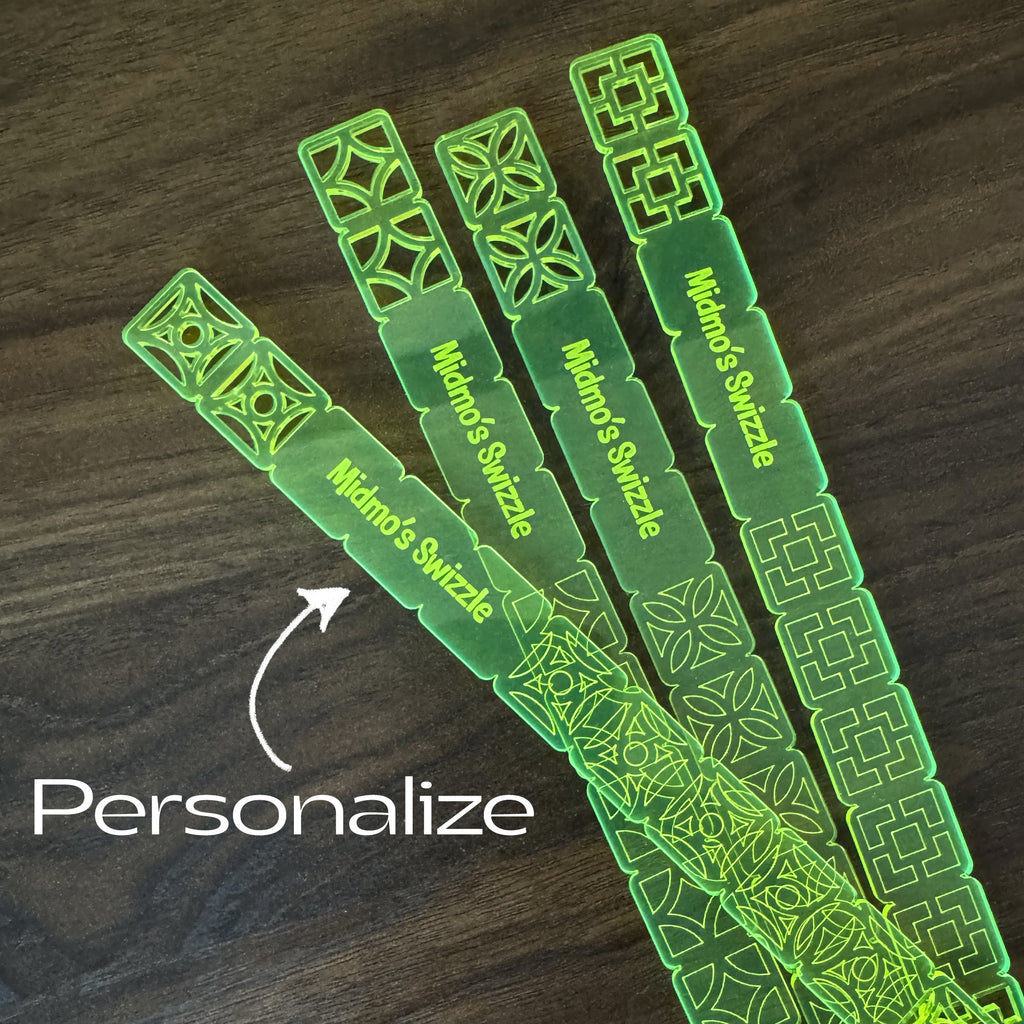 Breezeway Tile Mid-Century Modern Personalized XL Drink Stirrers with patterns on a wooden surface, featuring the brand 'Midmo's Swizzle'.
