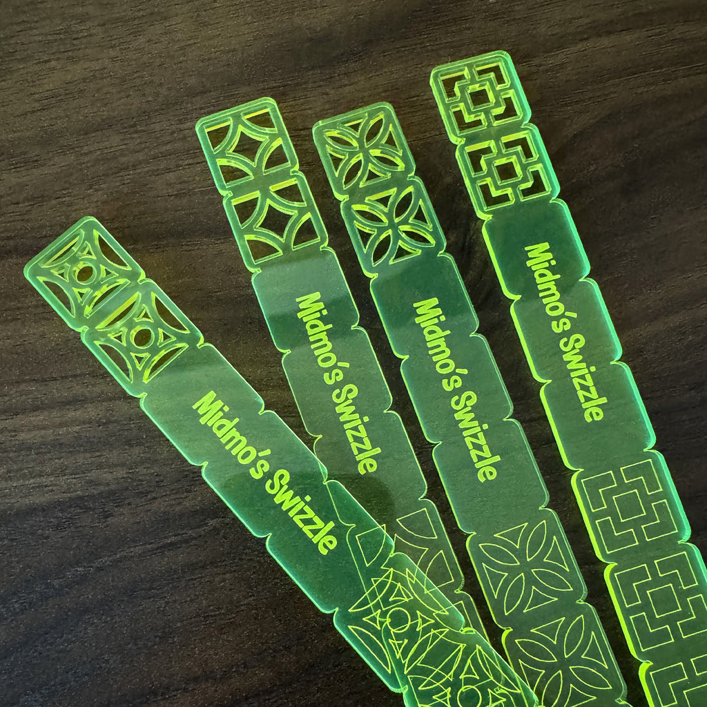 Breezeway Tile Mid-Century Modern Personalized XL Drink Stirrers with 'Midno's Swizzle' branding on a wooden surface