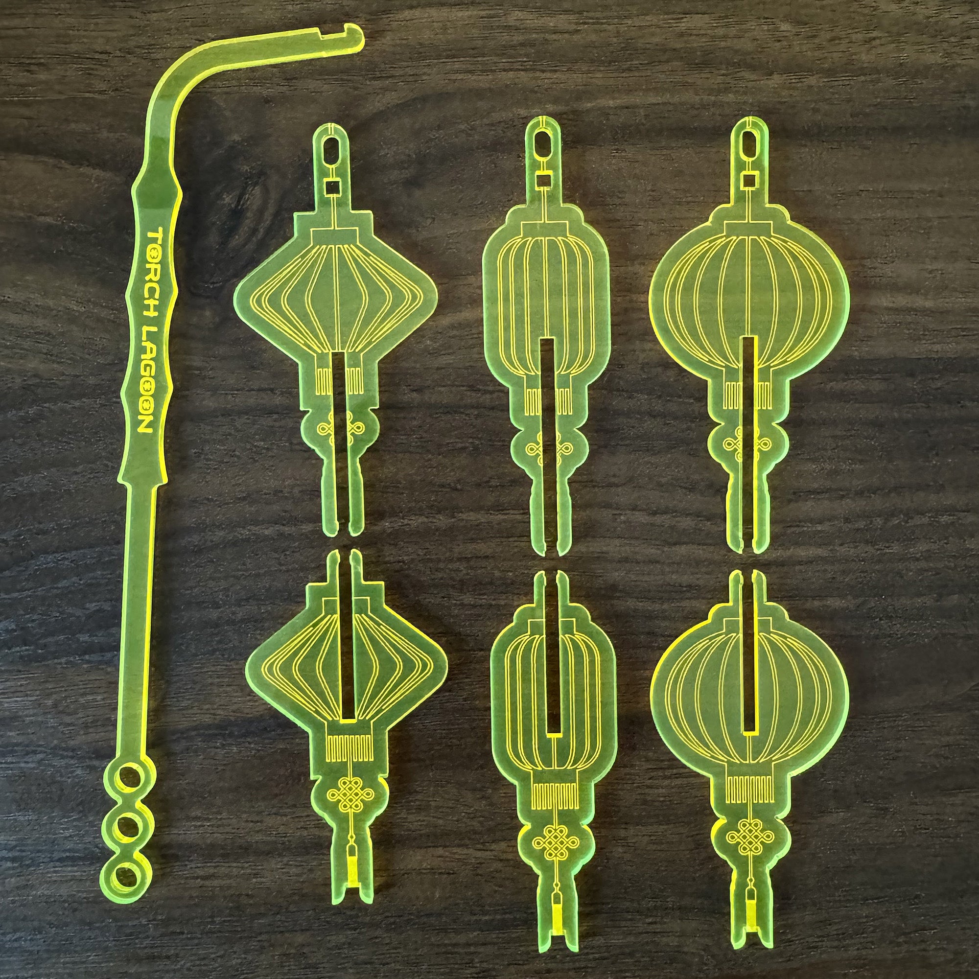 Options for Chinese Lantern "Torch Lagoon" Personalized Swizzle Sticks on a dark wooden surface