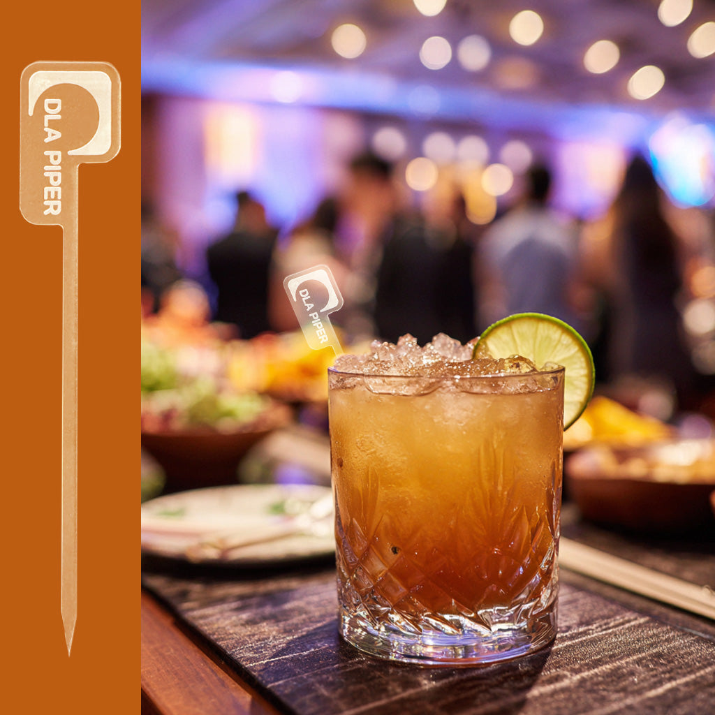 DLS Piper branded acrylic cocktail stirrer in a rocks glass at a corporate reception