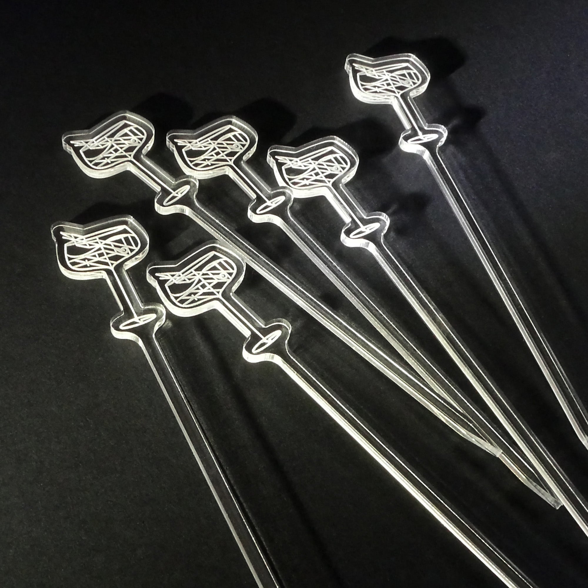 Set of six diaquiri cocktail garnish picks with drink illustrations on a black background