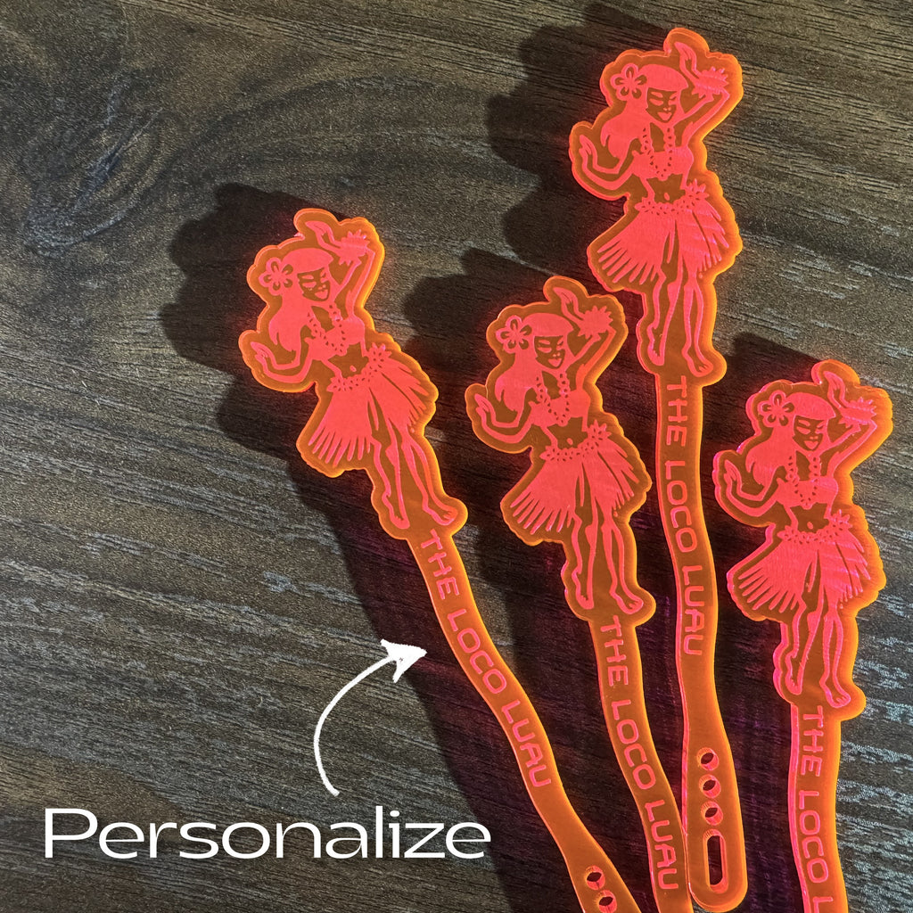 Set of four Hula Dancer "Loco Luau" Personalized Stubbie Swizzle Sticks with 'The Loco Luau' text on a wooden surface.