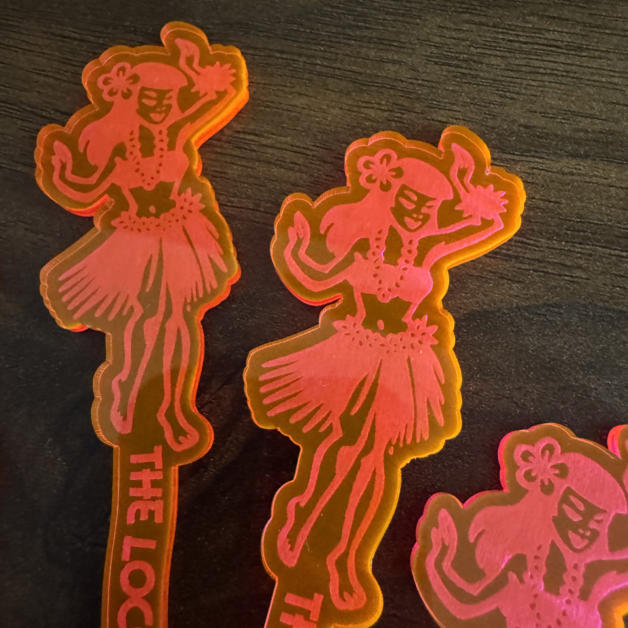 Detail photo of a Hula Dancer "Loco Luau" Personalized XL Swizzle Stick on a dark wooden surface