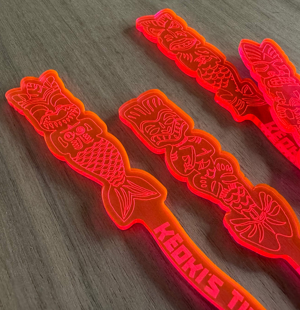 Mean Mermaids Personalized XL Swizzle Sticks on a wooden surface