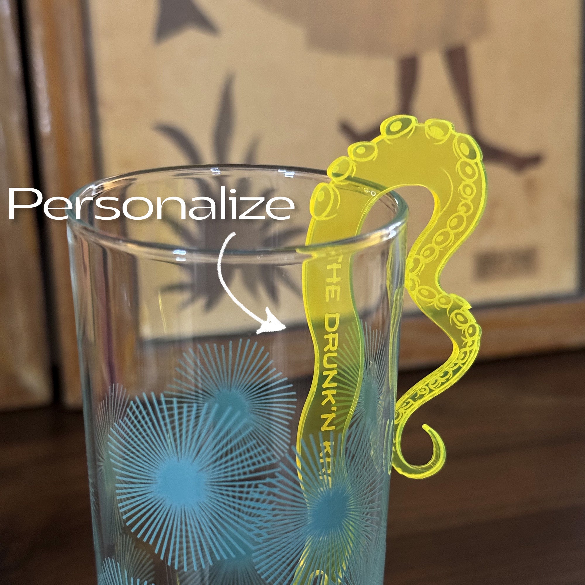 Clear glass Octopus Tentacle "The Drunken Kraken" Personalized Stubbie Swizzle Stick and 'The Drunk N Kraken' branding.