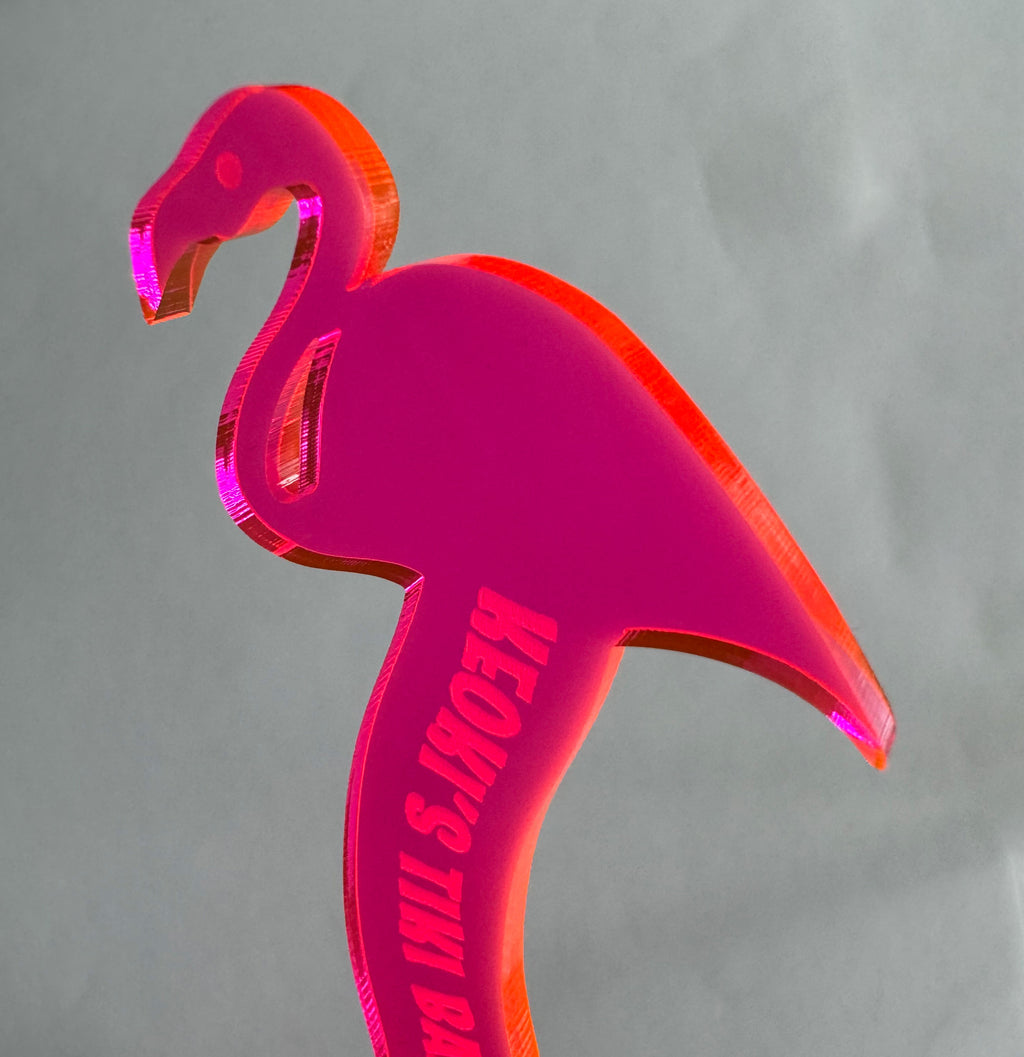 Pink Flamingo Personalized Drink Stirrer with 'KEOKI TIKI BAR' text on a gray background