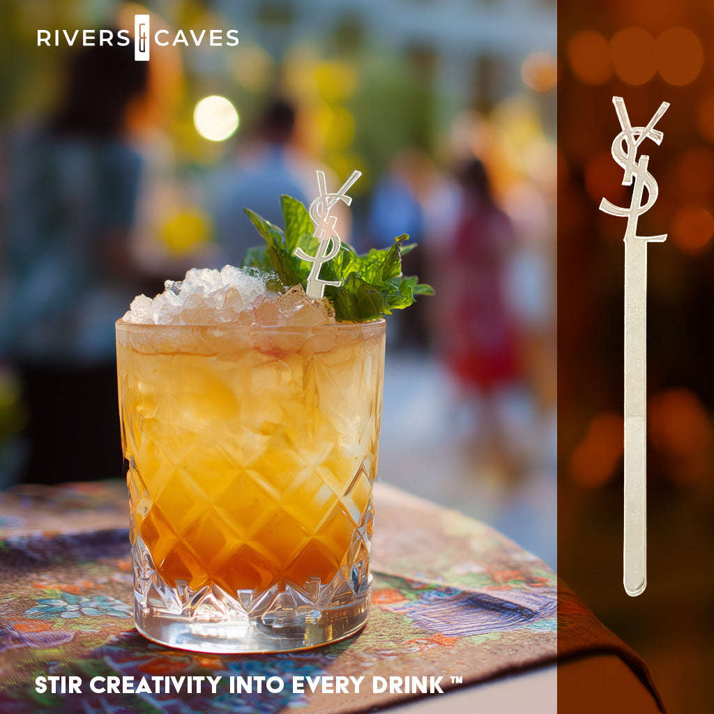 Branded cocktail stirrer with YSL (Yves Saint Laurent) cutout logo in an old fashioned glass at a corporate bar event