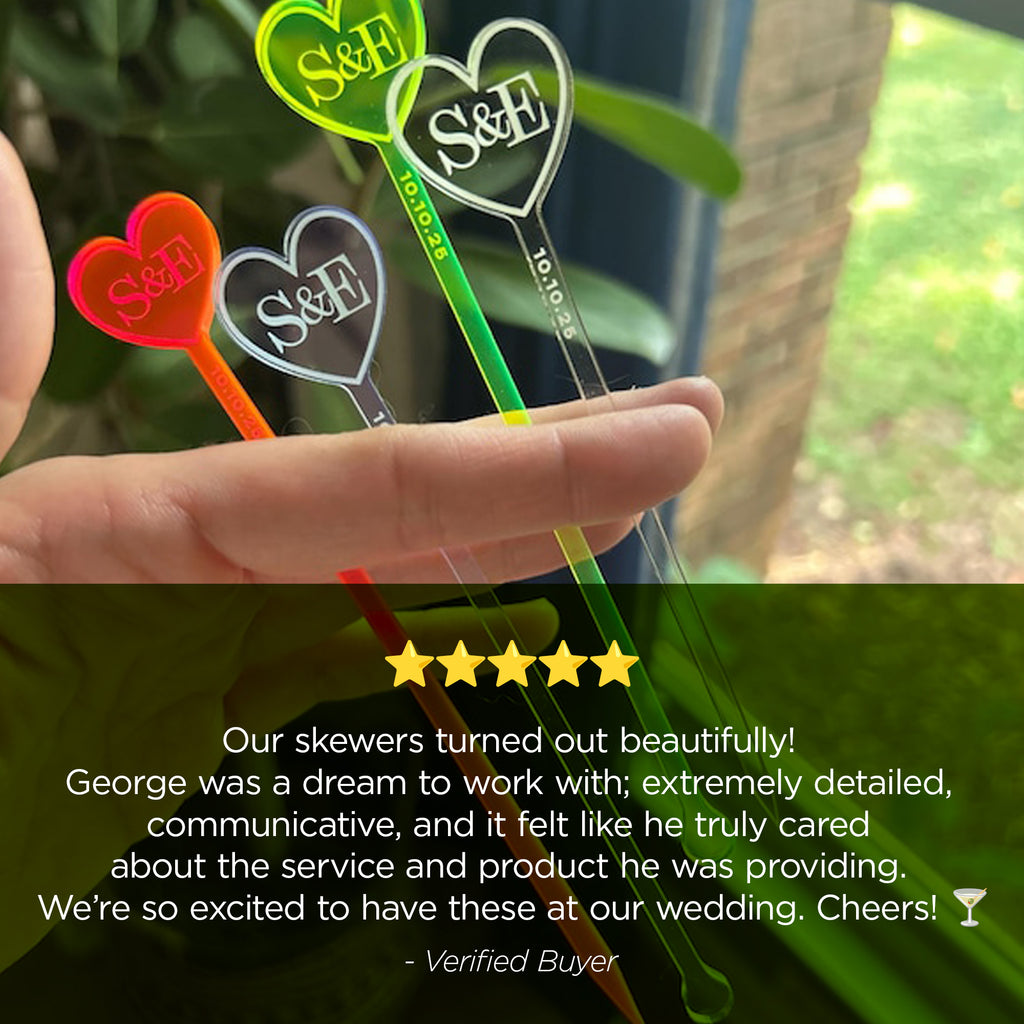 Heart-shaped skewers with initials held by a hand, with a five-star rating and customer review text overlay.