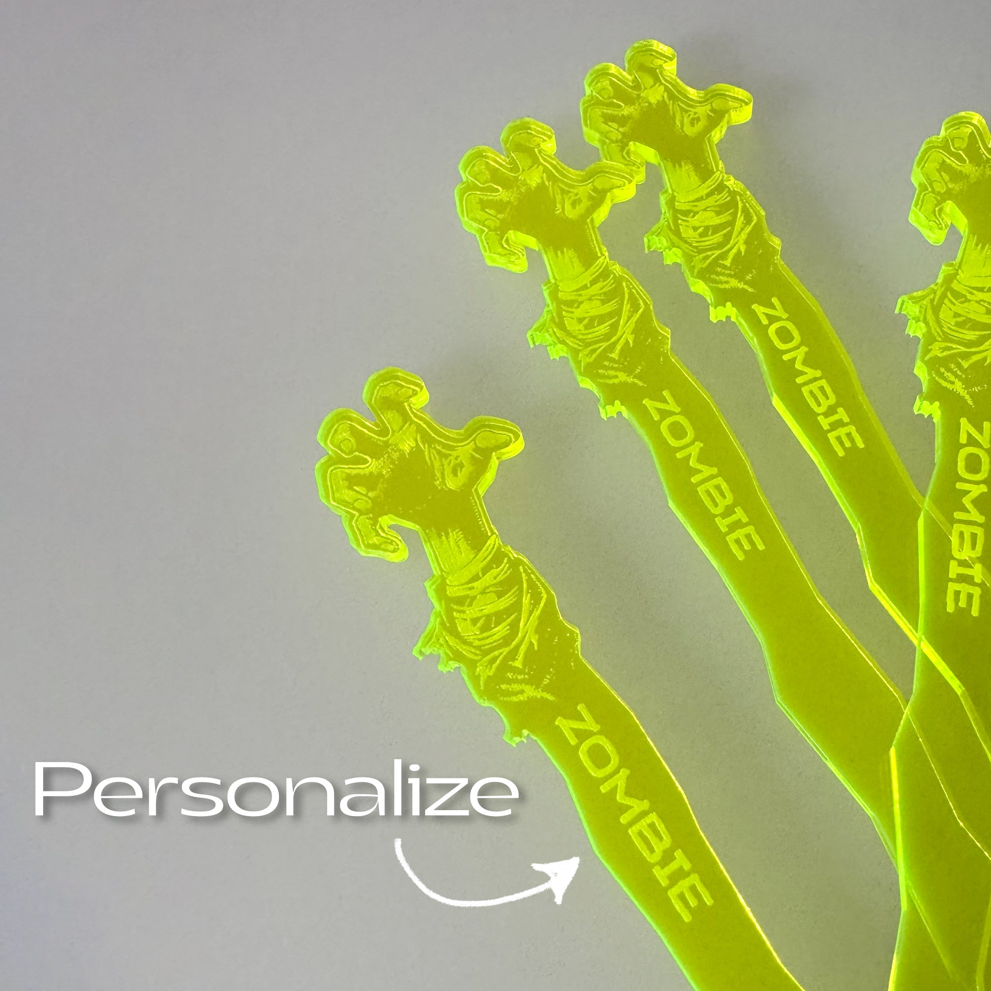 Zombie Personalized Stubbie Swizzle Sticks with 'Zombie' branding on a gray background.