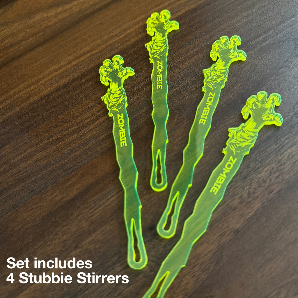 Zombie Personalized Stubbie Swizzle Sticks with 'Zombie' printed on them, on a dark wooden table, with text reading 'Set includes 4 Stubbie Stirrers'.